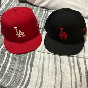 Pair of red and black new era LA snap back hats